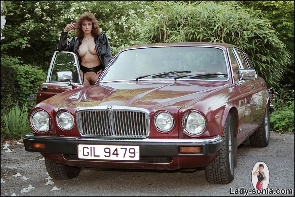Busty Mistress Mounting A Jaguar In Her Classy Gartered Stockings
